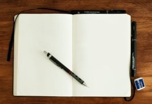 paper notebook with pen
